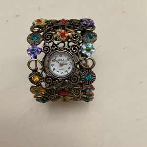 Vintage DBS Quartz costume jewelry watch, cuff, brass with decorative flowers.